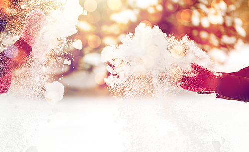 people, season, winter holidays and christmas concept - happy friends playing with snow outdoors