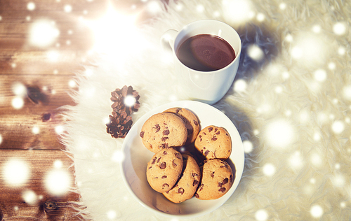 holidays, christmas, winter, food and drinks concept - close up of cups with hot chocolate or cocoa drinks and oat cookies on white fur rug