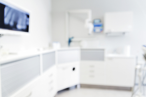 dentistry, medicine and stomatology concept - blurred modern dental clinic office interior bokeh