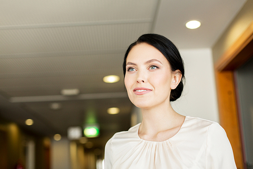 business and people concept - happy woman at corridor in hotel