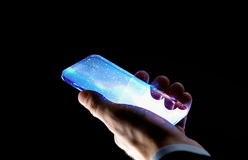 business, people and future technology concept - close up of businessman hand with space on transparent smartphone screen over black background