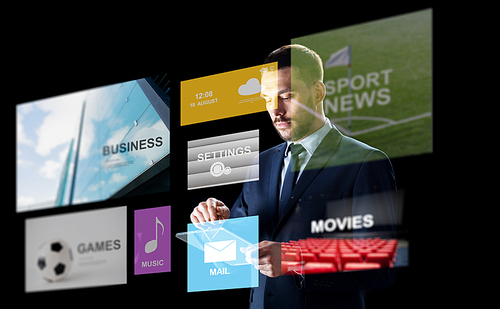 business, multimedia, people and technology concept - businessman in suit working with transparent tablet pc computer over black background