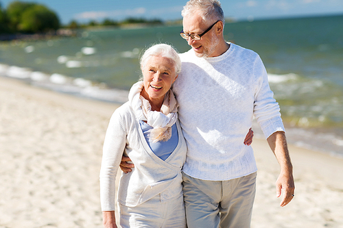 family, age, travel, tourism and people concept - happy senior couple hugging on summer beach