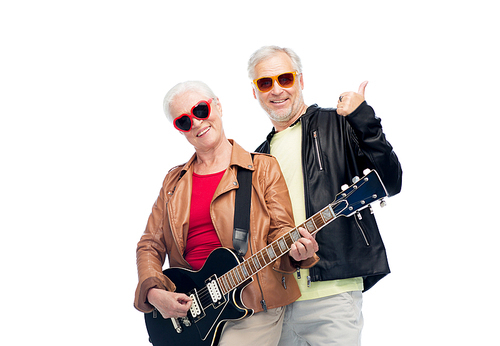 music, age and people concept - happy senior couple in sunglasses with electric guitar showing thumbs up