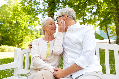 old age, relationship and people concept - happy senior couple hugging in city park