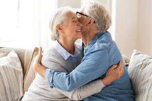 relationships, old age and people concept - happy senior couple hugging at home