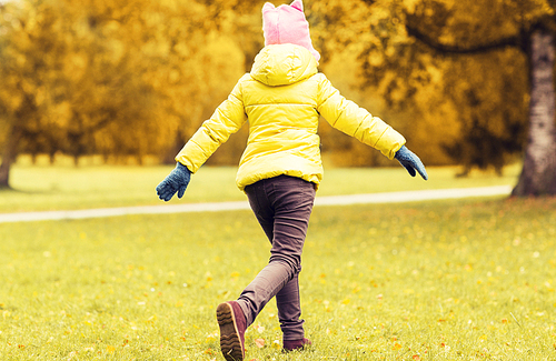 season, childhood, activity, motion and people concept - happy little girl running in autumn park from back