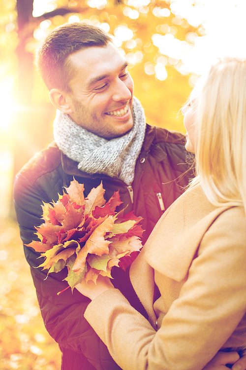 holidays, love, travel, tourism, relationship and dating concept - romantic couple in the autumn park