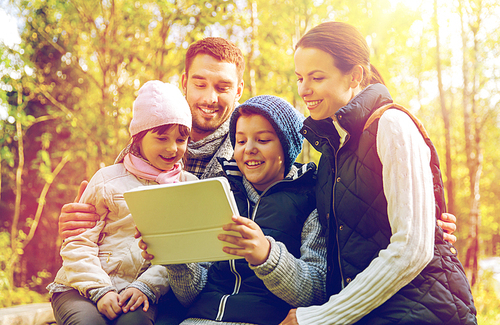 hike, travel, tourism and people concept - happy family with tablet pc computer at camp in woods