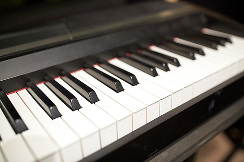music, art, musical instruments and entertainment concept - close up of grand piano keyboard