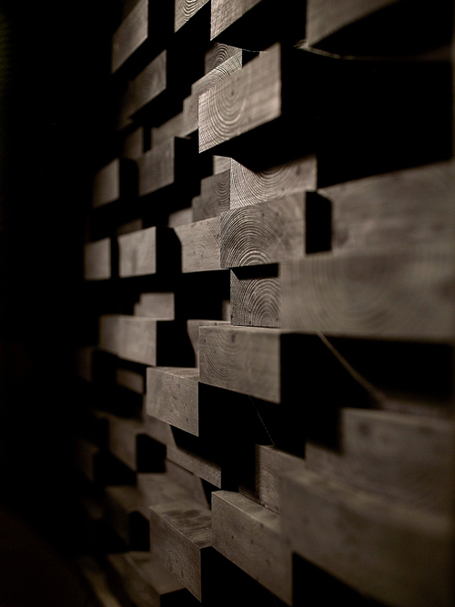 acoustic materials, texture, interior and soundproofing concept - wooden brick wall decoration at sound recording studio