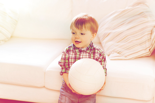 childhood and people concept - happy little baby boy with ball at home