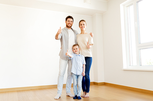 mortgage, people, housing and real estate concept - happy family with child moving to new home and showing thumbs up