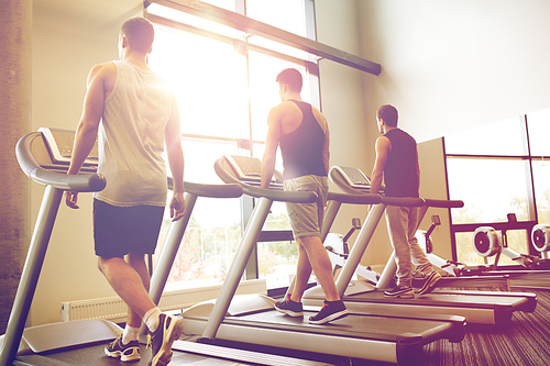 sport, fitness, lifestyle, technology and people concept - men exercising on treadmill in gym