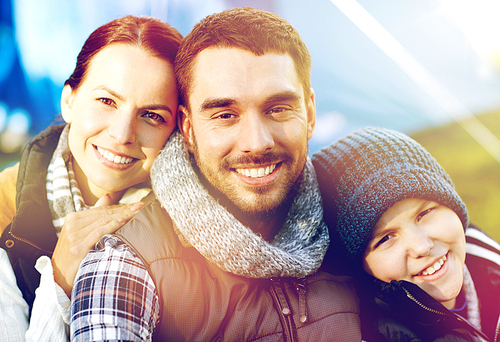 tourism, hike and travel concept - happy family portrait over tent at camp site