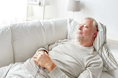 old age, rest, comfort and people concept - senior man sleeping on sofa at home