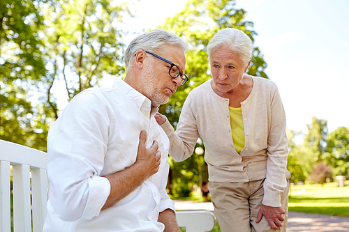 old age, health problem and people concept - senior man feeling sick at summer park