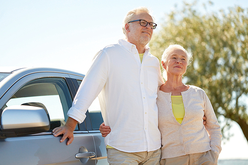 road trip, travel and old people concept - happy senior couple hugging at car in summer