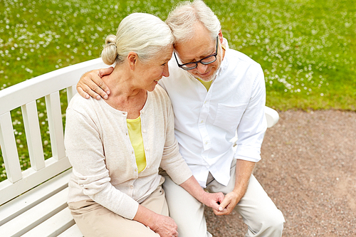 old age, relationship and people concept - happy senior couple hugging in city park