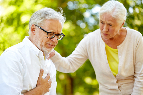 old age, health problem and people concept - senior man feeling sick at summer park