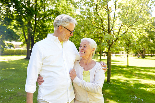 old age, relationship and people concept - happy senior couple hugging in city park