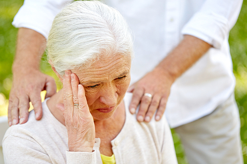 health, stress, old age and people concept - close up of senior woman suffering from headache outdoors