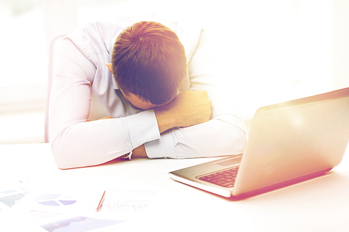 business, people, fail, paperwork and technology concept - businessman with laptop computer and papers working in office