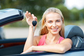 movable property, security and transport concept - happy young woman with convertible car key