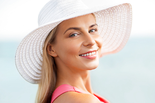summer, fashion and people concept - portrait of beautiful smiling woman in sun hat