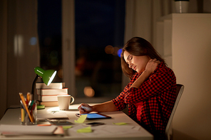education, freelance, overwork and people concept - tired woman or student girl with tablet pc computer touching neck at night home