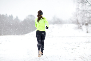fitness, sport and healthy lifestyle concept - woman running outdoors in winter