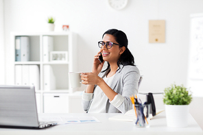 business, technology, communication and people concept - happy smiling businesswoman or secretary calling on smartphone and  coffee at office