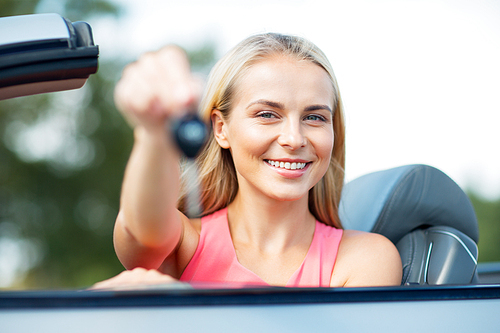 movable property, security and transport concept - happy young woman with convertible car key