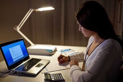 business, accounting, overwork, deadline and people concept - woman with tax form and calculator working at night office