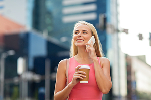 communication, technology and people concept - happy smiling young woman with coffee calling on smartphone on city street