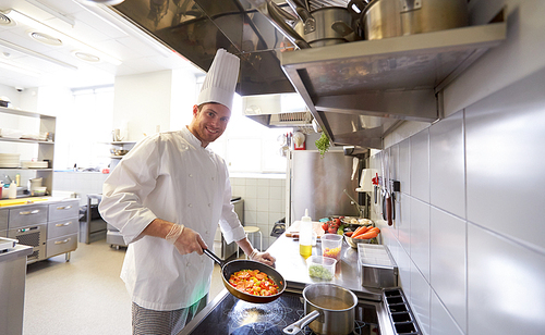 cooking food, profession and people concept - happy male chef cook with pot and frying pan at restaurant kitchen