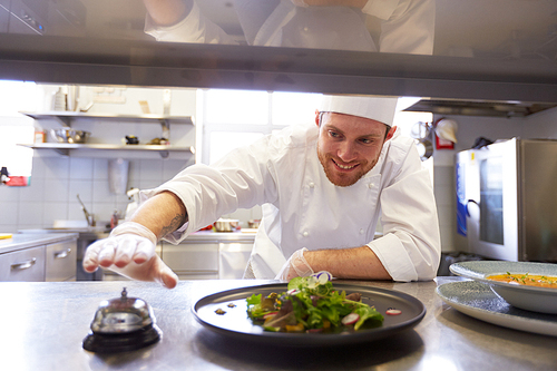 food cooking, profession and people concept - happy male chef cook with plate of soup and salad ringing bell at restaurant kitchen table
