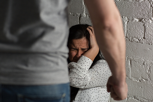 domestic violence, abuse and people concept - man beating helpless scared woman