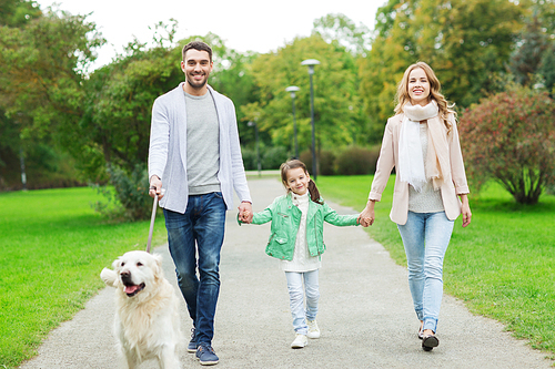 family, pet, domestic animal and people concept - happy family with labrador retriever dog walking  in summer park