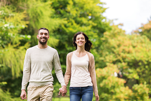 love, relationship, family and people concept - happy couple walking in summer park