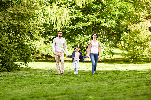 family, parenthood, adoption and people concept - happy mother, father and little girl walking in summer park