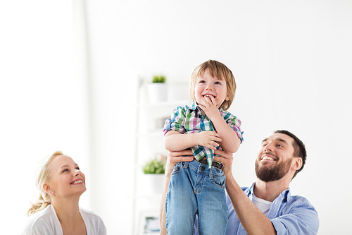 family, adoption and people concept - happy child with parents at home