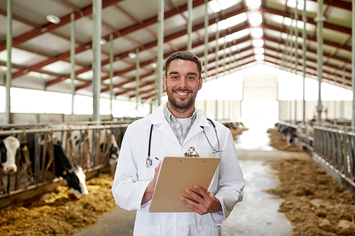 agriculture industry, farming, people and animal husbandry concept - veterinarian or doctor with clipboard and herd of cows in cowshed on dairy farm