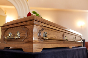 funeral and mourning concept - wooden coffin in church