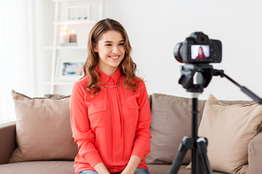 blogging, technology, videoblog, mass media and people concept - happy smiling woman or . with camera recording video at home