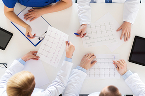 medicine, healthcare and cardiology concept - group of doctors with cardiograms, clipboard and tablet pc computers at hospital