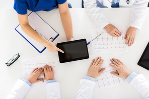 medicine, healthcare and cardiology concept - group of doctors with cardiograms, clipboard and tablet pc computer at hospital