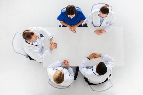 medicine, healthcare and people concept - group of doctors sitting at empty table
