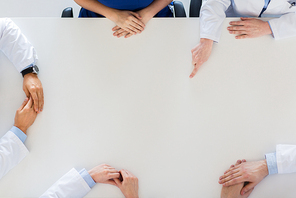 medicine, healthcare and people concept - doctor hand showing something imaginary on table
