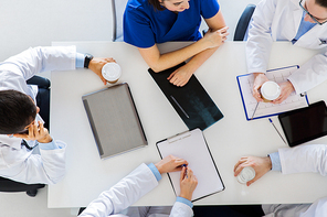 medicine, healthcare and people concept - group of doctors having coffee break at hospital